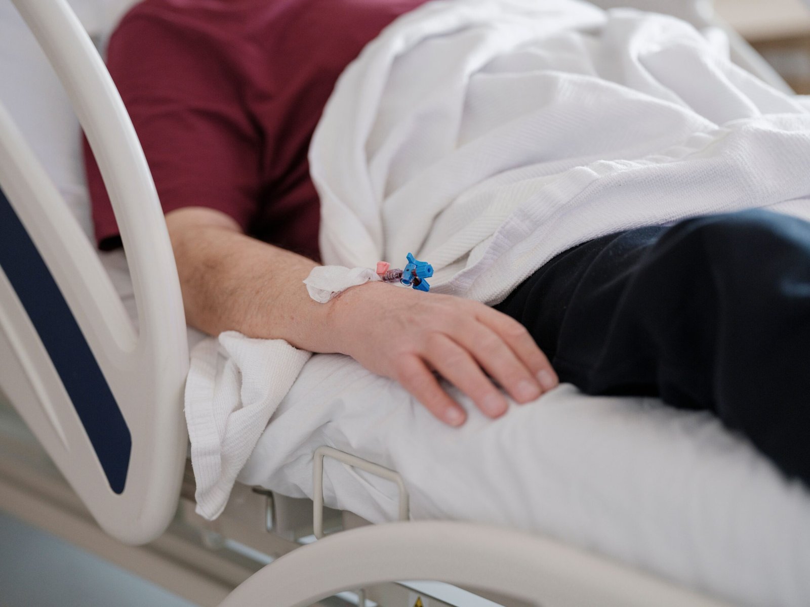 A business man is laying on the hospital bed